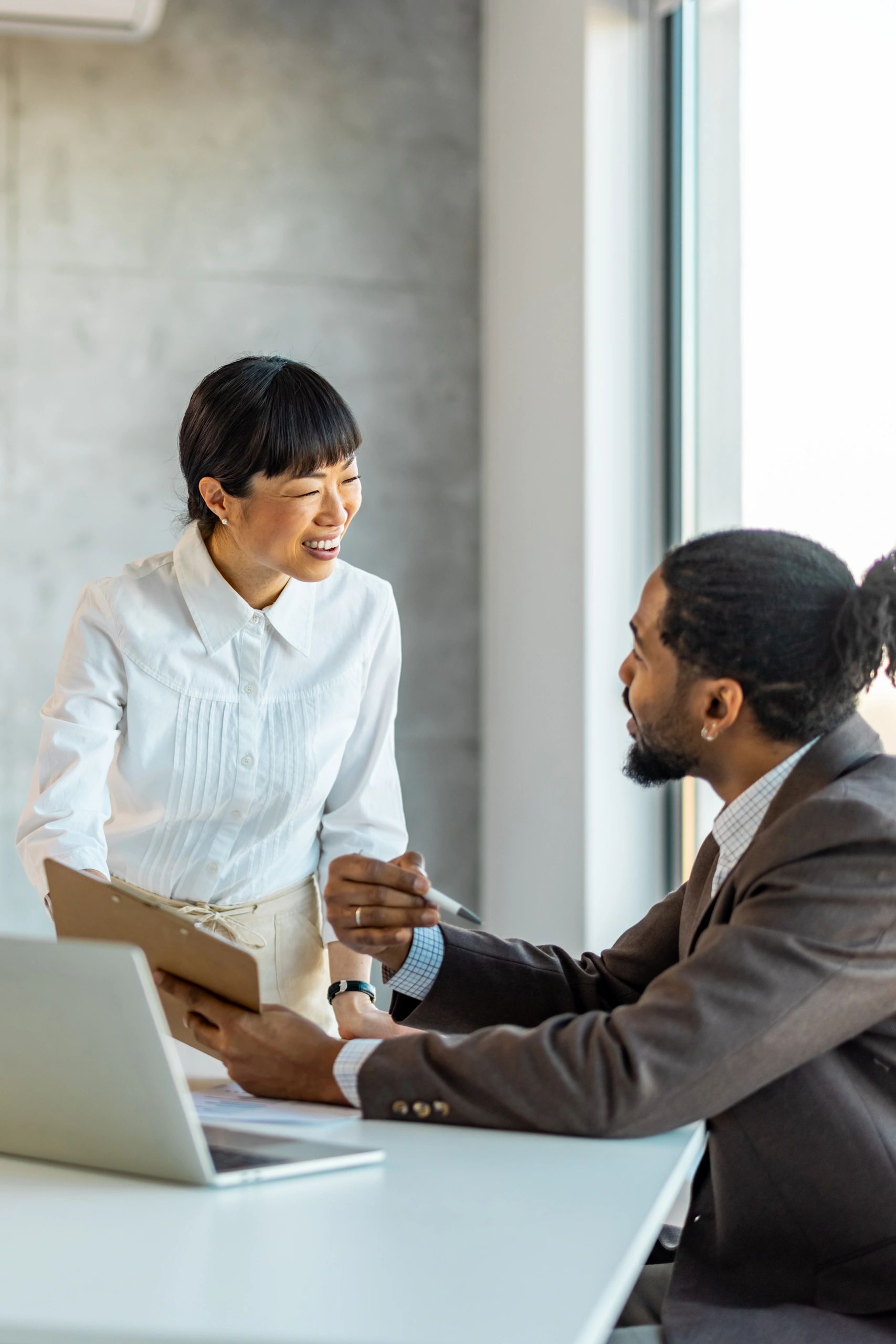 Two colleagues in discussion during a creative planning session